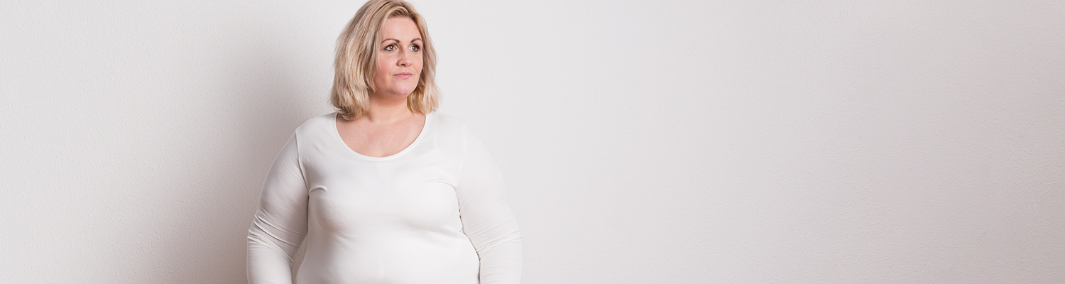 Portrait of an attractive overweight woman in studio on a white background. 