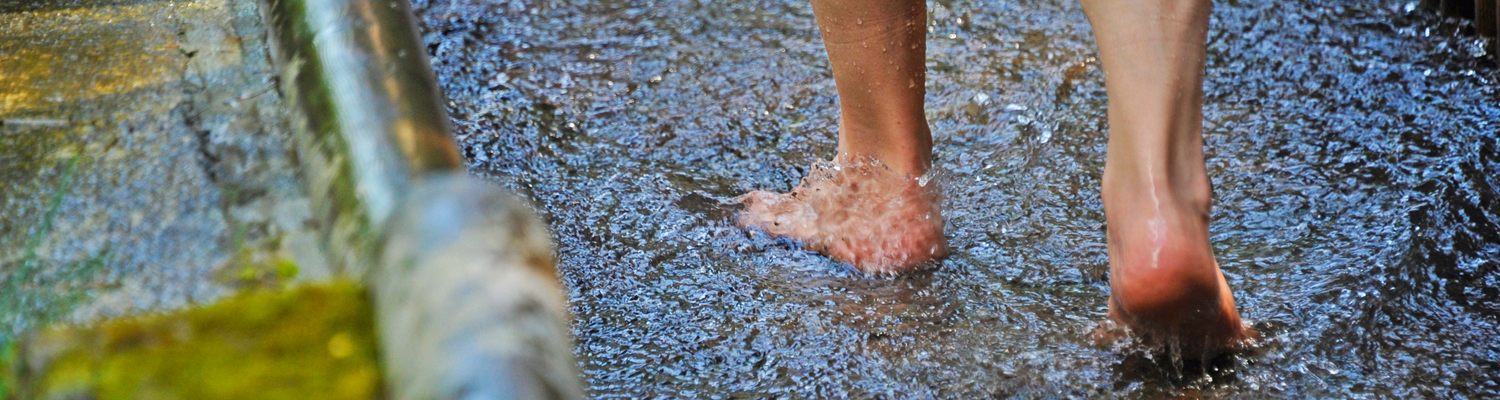 Feet walking through water